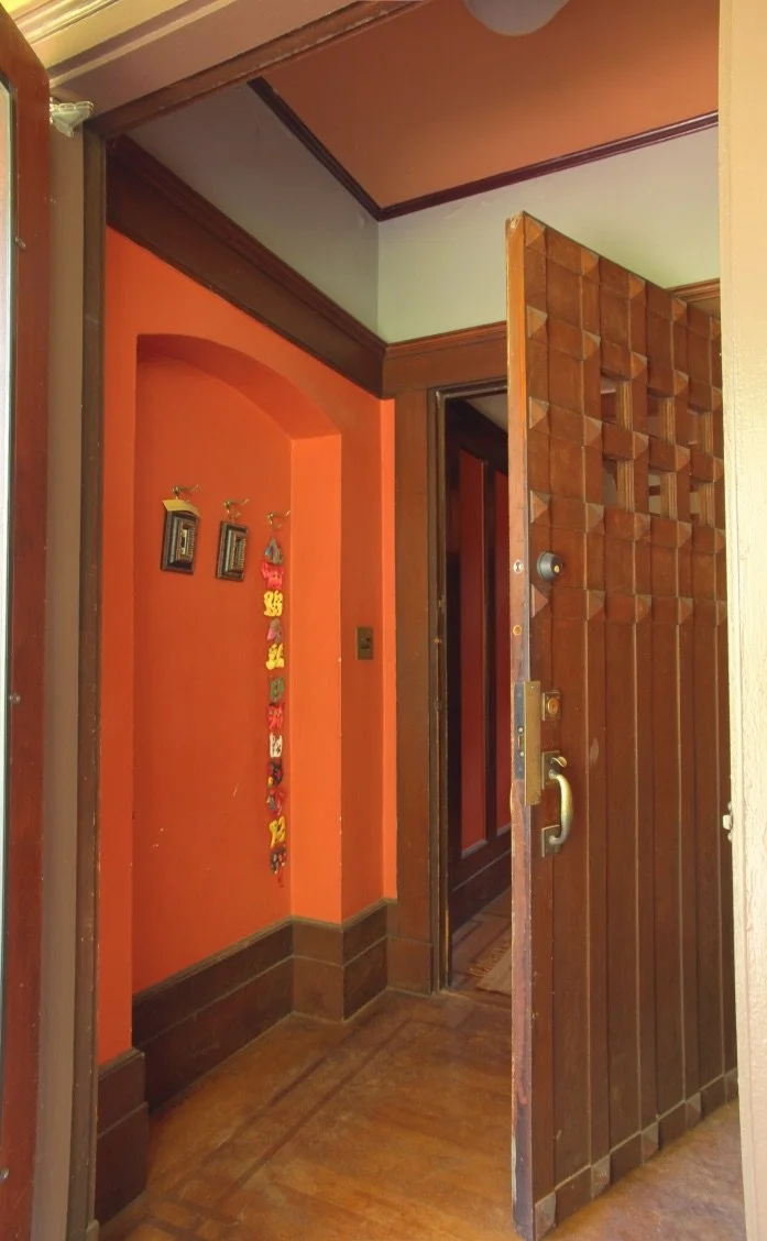 Orange paint accents a classically remodeled door